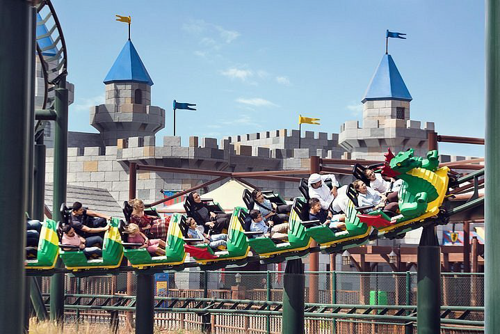 A group of people riding a roller coaster  Description automatically generated