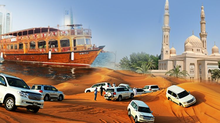 A group of cars in sand with a boat in the background  Description automatically generated